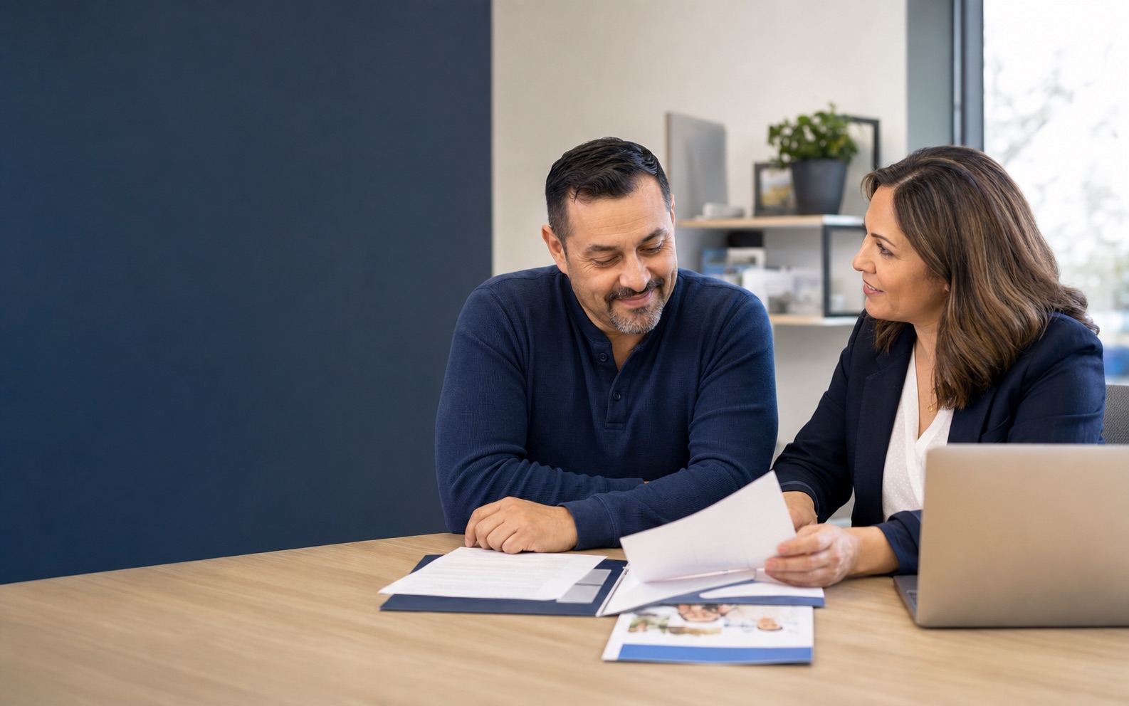 A vocational counselor helping a worker review voucher and training information
